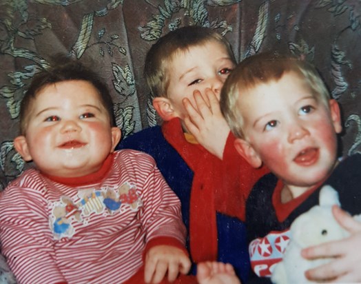 Jon as a very smiler baby with his two big brothers circa 2001