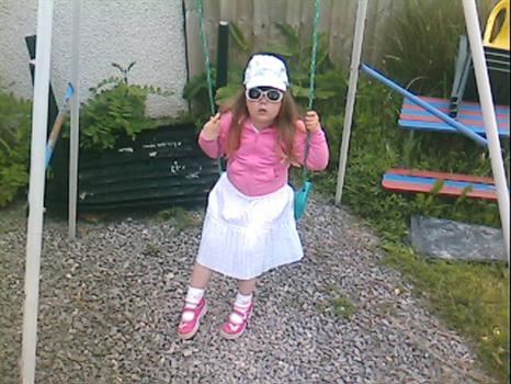 Abbie on the swing with her sunglasses