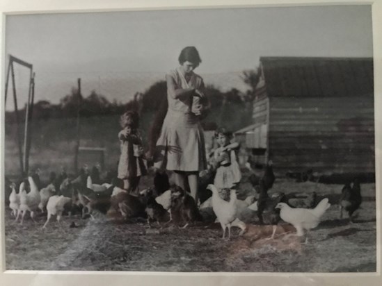 Valerie (4) and Gill (2) feeding the chickens with Mother - 1930