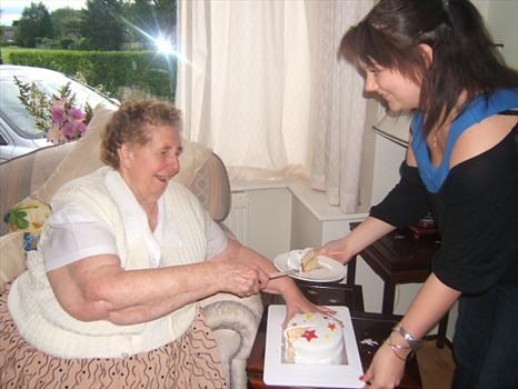 Nana and Rebecca cutting the birthday cake