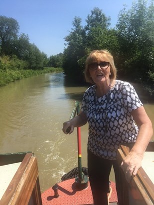 Barbara having a go at steering our barge on The Grand Union Canal