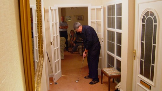 Harry practicing his putting in our hallway after a few drinks