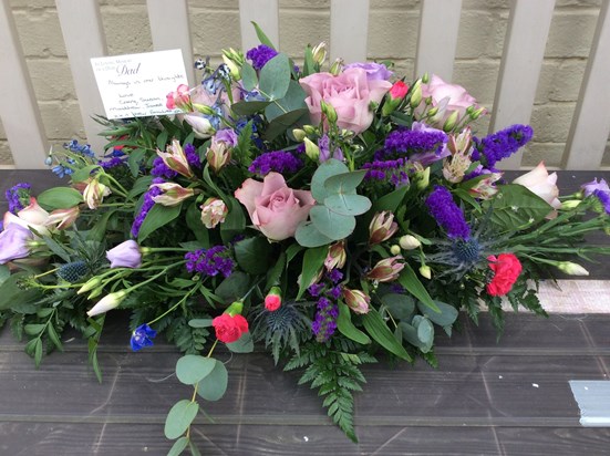 Floral display brought home from the coffin to be laid on the cremation plot 