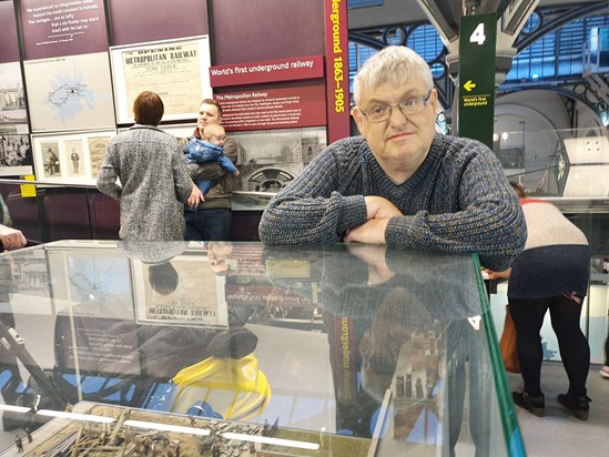 dave transport museum leaning on glass exhibit