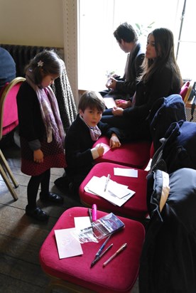 Friends writing messages and thoughts for the book of memories