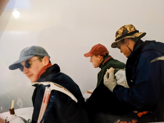 Lunch in the mountain fog. Dan with ice axe at ready for tricky descent, New Zealand 1998