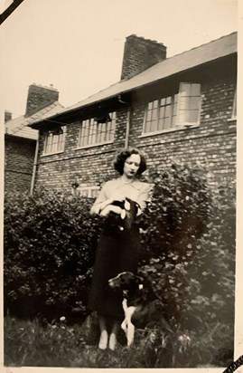 Moira holding her cat, Frisky, with her dog Peggy 1952