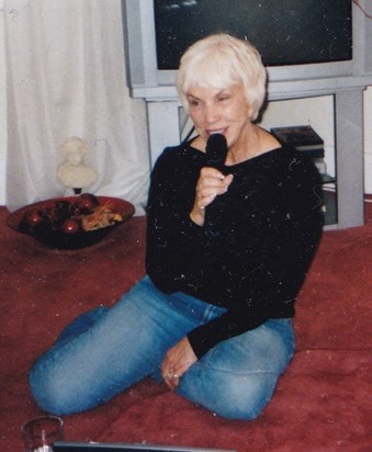 Beth loved to sing. Photo circa 1990 - check out the television!