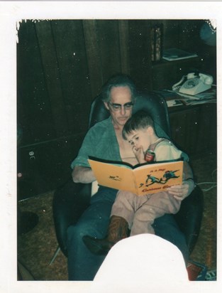 Grandpa reading Curious George to Kevin