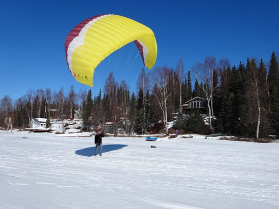 Kevin kiting his paraglider on Nancy Lake in front of our cabin