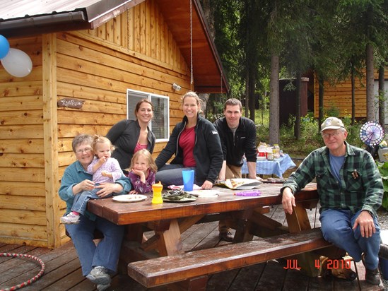 The Mitchell family in front of their cabin in Cooper Landing