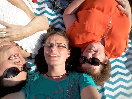 Pat, Maralyn and I laying on the ground, laughing and smiling 