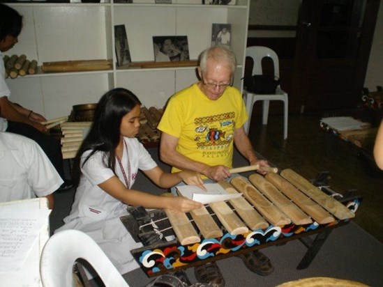 Rod trying to learn an indigenous musical instrument from the Philippines.