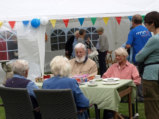Supporters enjoying our garden party and helping to raise £450.