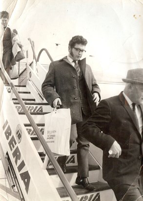 dad coming off the Plane in the days were you wore a suit and tie for Air Travel!