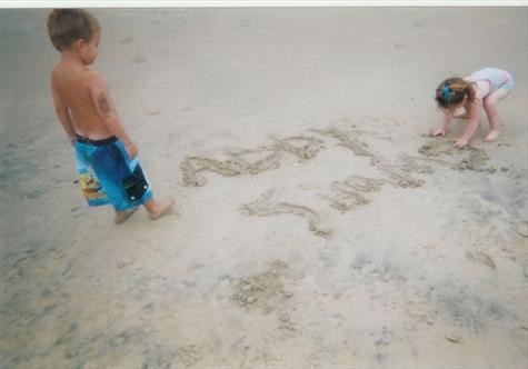Mommy wrote your sissys name in the sand