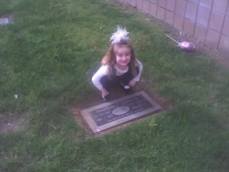 Your sis Abby at your headstone she always kisses your picture on there