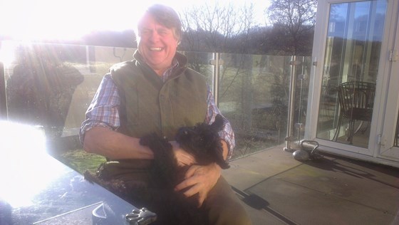 Jon loving his dog Esk in the sunshine at his lovely home 