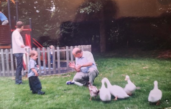 Grandad with grandson Jacob feeding swans