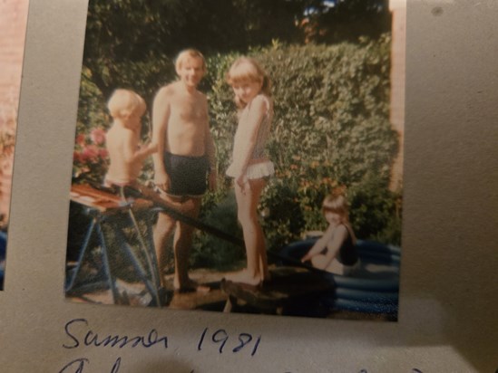 Dad with us 3 kids in the back garden