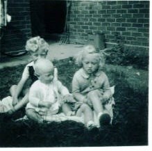 Toddler Steve with his siblings Pat & Tony in garden at Waterford Rd, Ipswich 1953