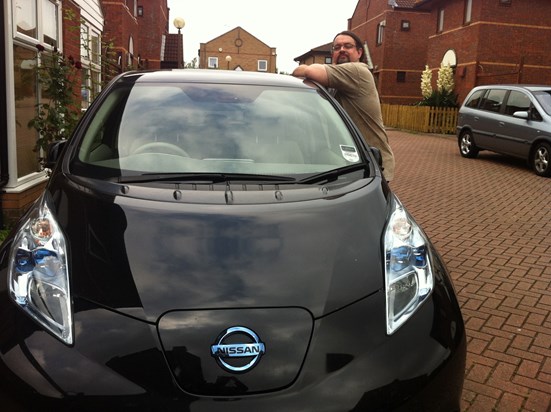 A very proud owner of a brand new Nissan Leaf