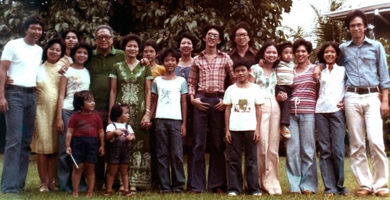 With Jun, baby Davy and the Bautista family in their front yard