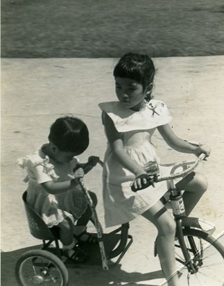 Cherie on a trike with younger sister Aggie